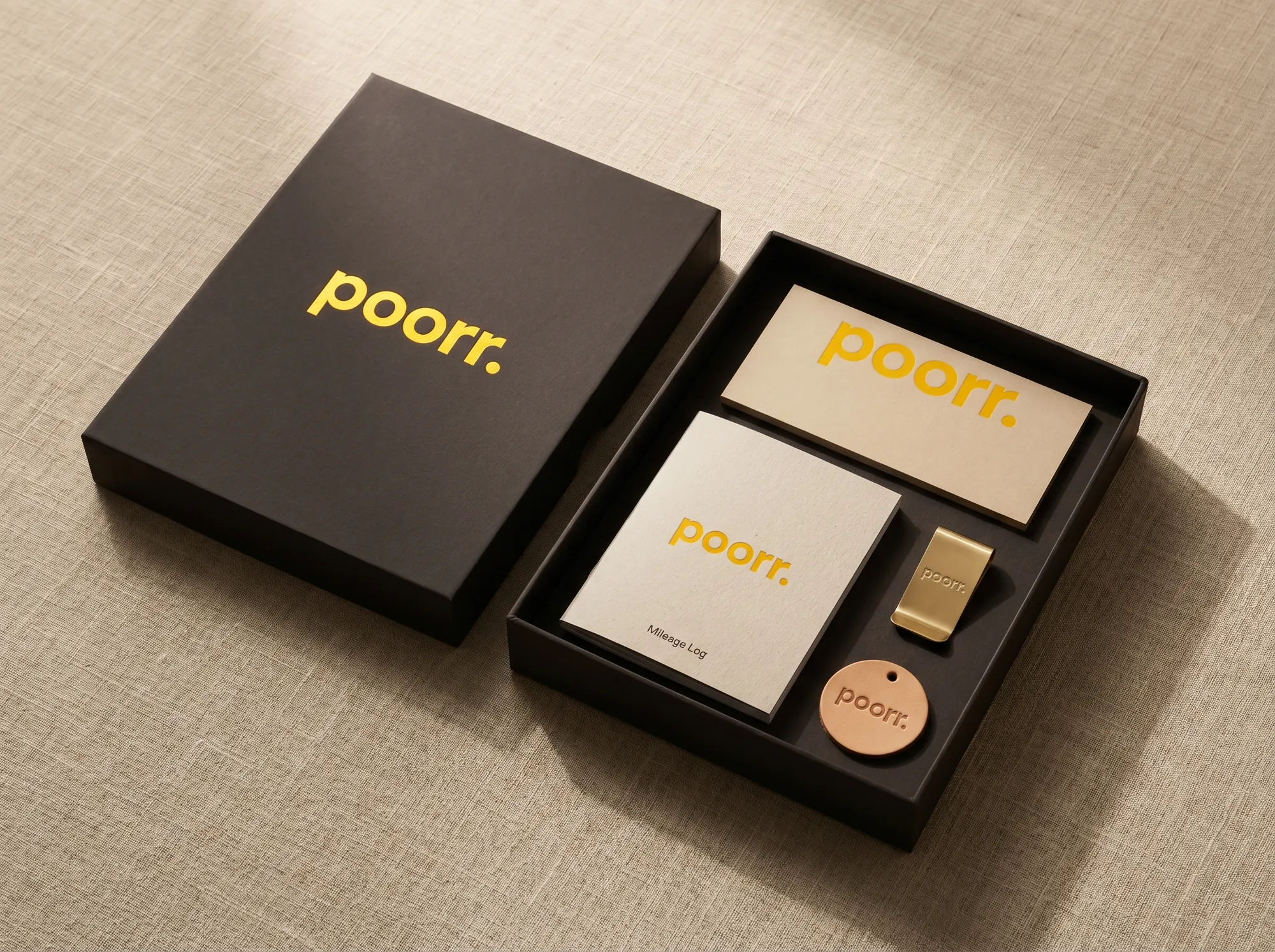 Poorr Driver Welcome Box (Boxed Kit) — A boxed welcome kit shipped to new gig subscribers — a printed Mileage Log, a tax-buffer printed reference card, a brass dashboard clip, and a small leather hangtag.